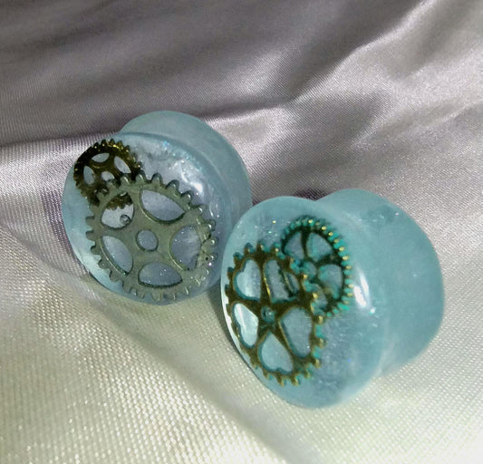 18mm Body Piercing Ear Plugs. Translucent Light Blue w/gears embedded in epoxy resin.
